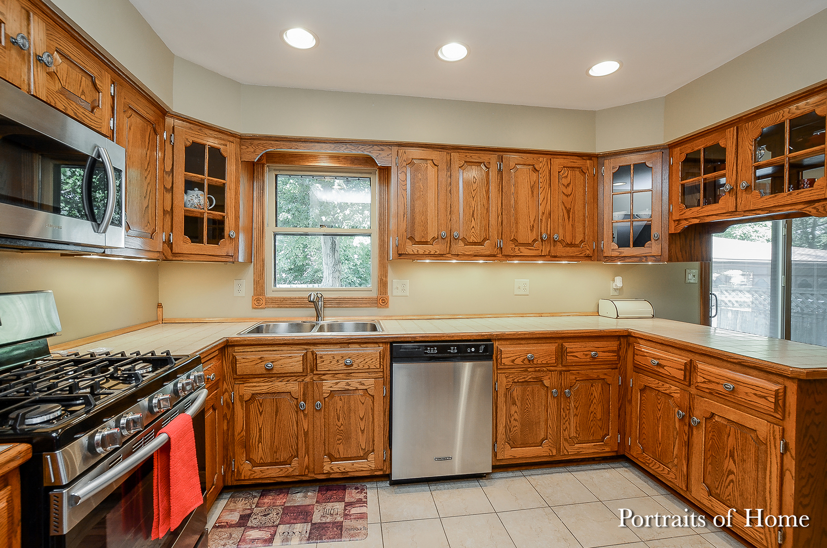 1805 South Tyler Road St. Charles, IL 60174 - Photo 5 of 17 a kitchen with stainless steel appliances granite countertop a stove a sink dishwasher and cabinets with wooden floor