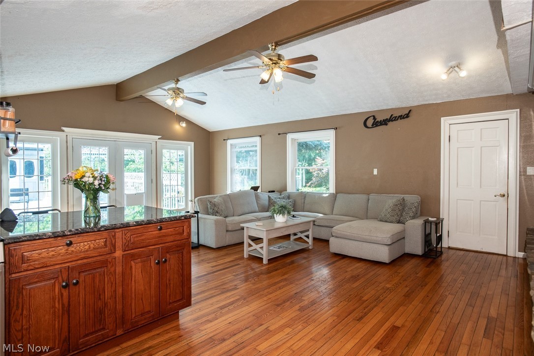 7075 Valley View Road Hudson, OH 44236 - Photo 3 of 17 Living room with vaulted ceiling, hardwood flooring, and ceiling fan. French doors lead out to the beautiful deck