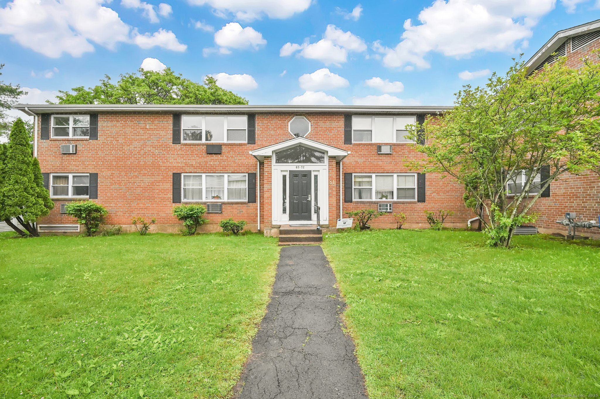 a front view of house with yard and green space