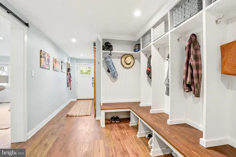 a hallway with furniture and wooden floor