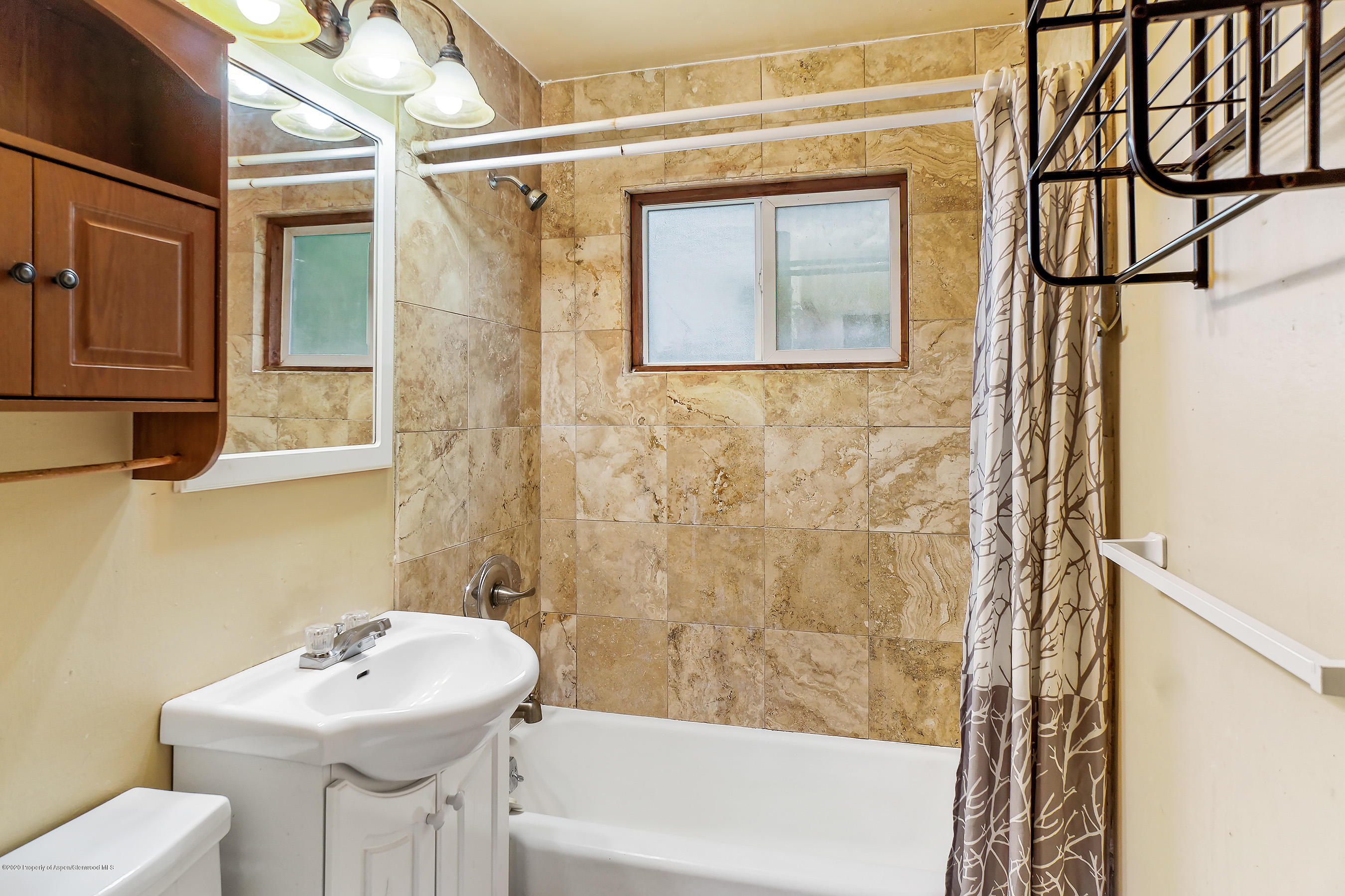 423 Elm Avenue Rifle, CO 81650 - Photo 15 of 23 a bathroom with a sink a mirror and a shower