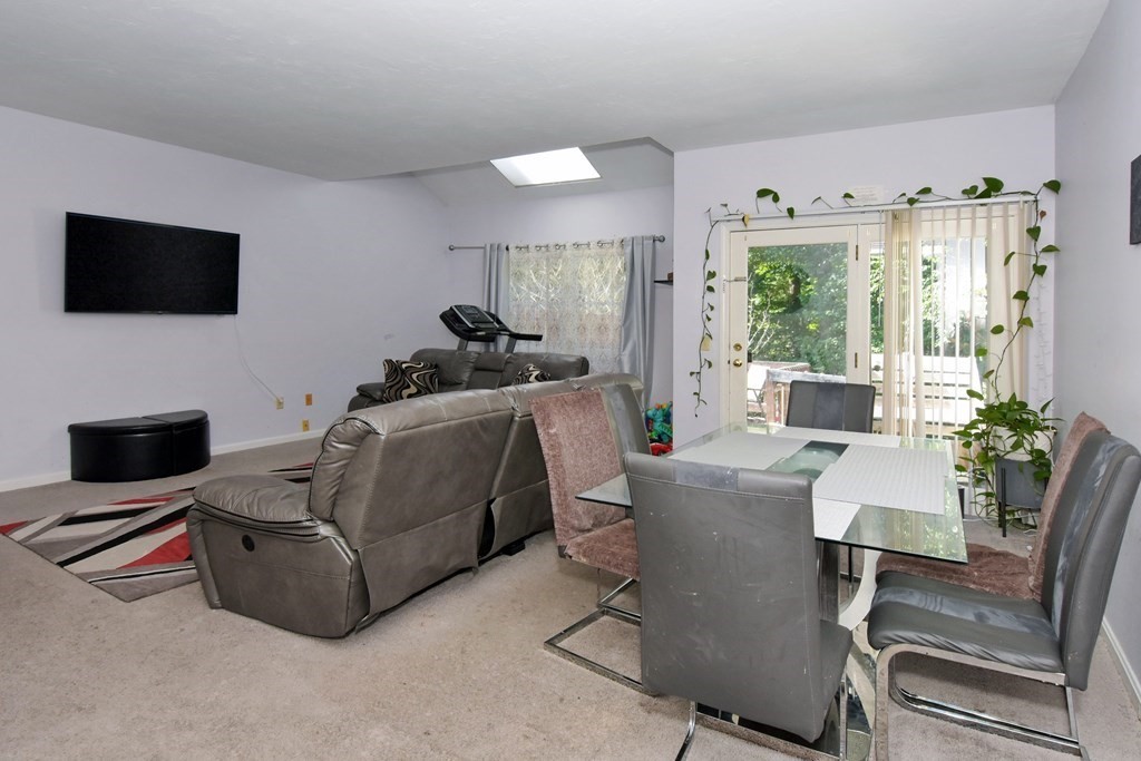 17 Highfield Road, Unit C Charlton, MA 01507 - Photo 11 of 31 a living room with furniture a flat screen tv and a fireplace