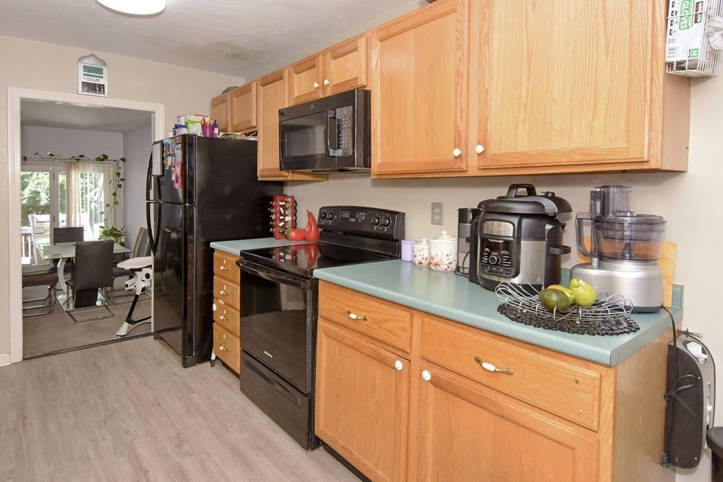 17 Highfield Road, Unit C Charlton, MA 01507 - Photo 3 of 31 a kitchen with stainless steel appliances granite countertop a refrigerator stove and sink