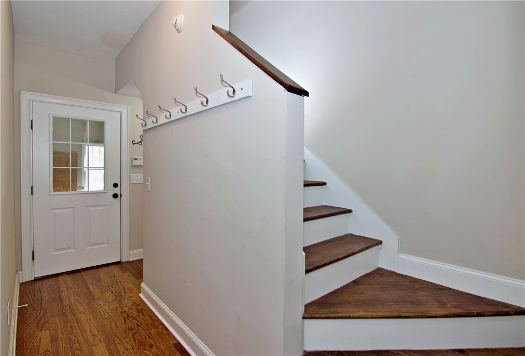 7893 Athens Road Carnesville, GA 30521 - Photo 26 of 50 This inviting entry features rich hardwood flooring and a functional staircase leading to additional levels.