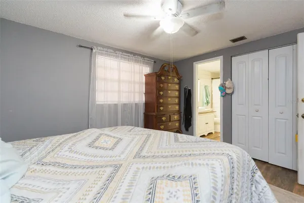a bedroom with a large bed and a chandelier