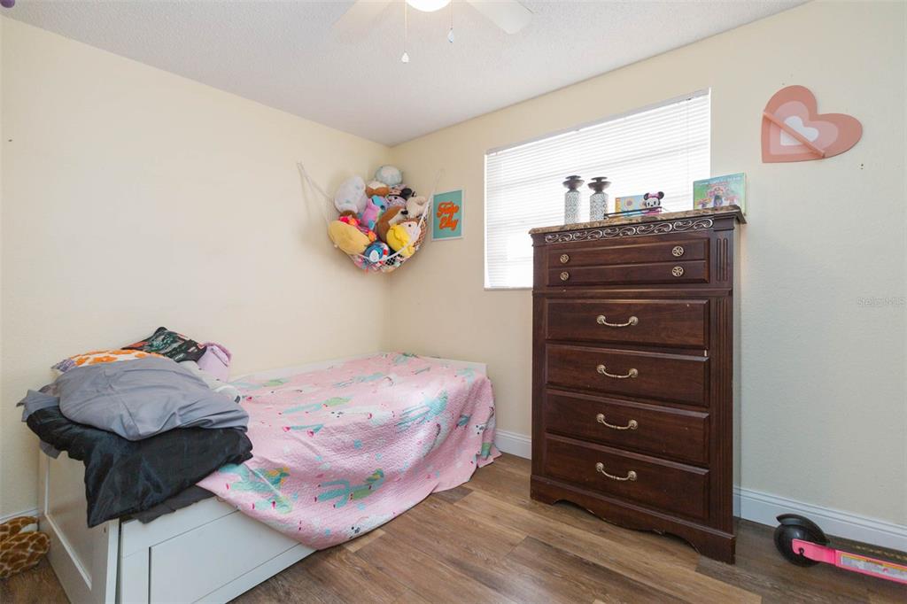 821 Walnut Drive Seffner, FL 33584 - Photo 12 of 19 a bedroom with a bed and a dresser