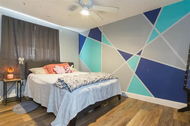 a bedroom with a bed and a mirror