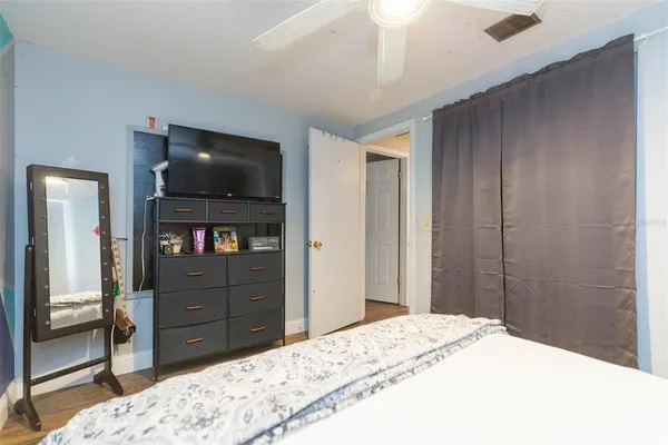 a bedroom with a bed and a television