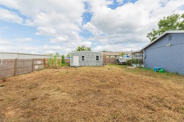 a view of backyard with large trees