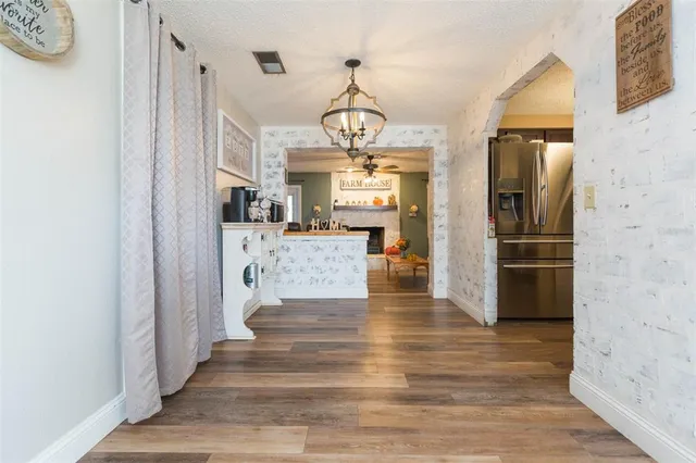 a view of a hallway view with wooden floor and staircase