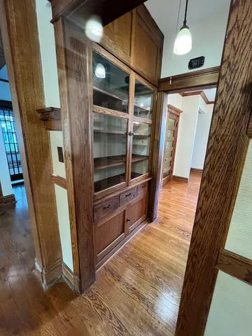 a view of hallway with stairs and wooden floor