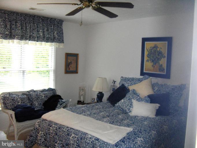 6811 Mallow Court Springfield, VA 22152 - Photo 16 of 30 a bedroom with a large bed and a window