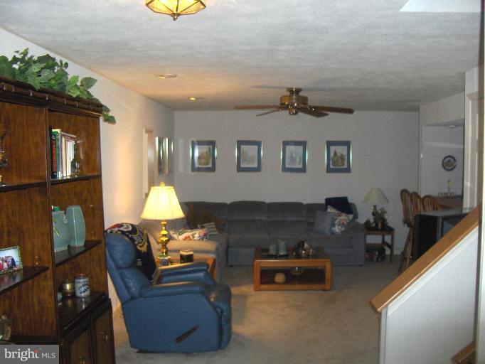 6811 Mallow Court Springfield, VA 22152 - Photo 19 of 30 a living room with furniture and a lamp