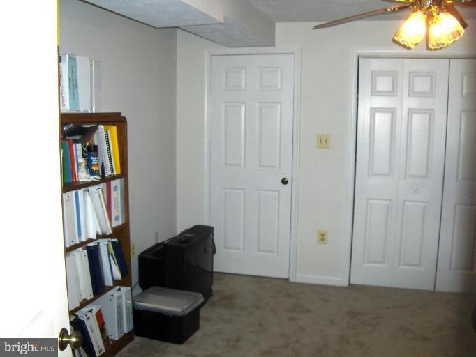 6811 Mallow Court Springfield, VA 22152 - Photo 22 of 30 a living room with furniture and a book shelf