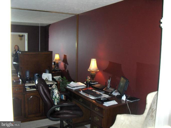 6811 Mallow Court Springfield, VA 22152 - Photo 4 of 30 a living room with furniture and a lamp