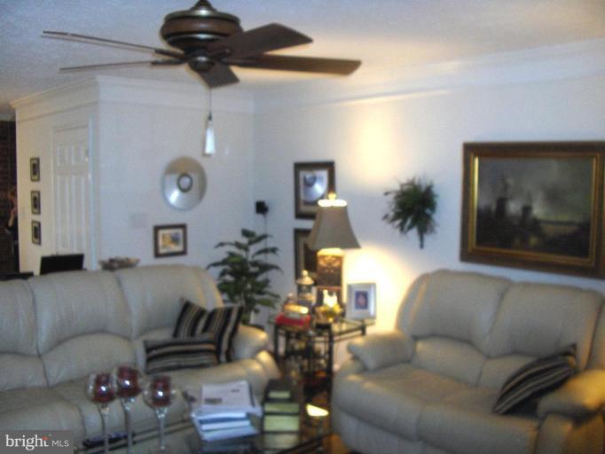 6811 Mallow Court Springfield, VA 22152 - Photo 6 of 30 a living room with furniture and a wooden floor