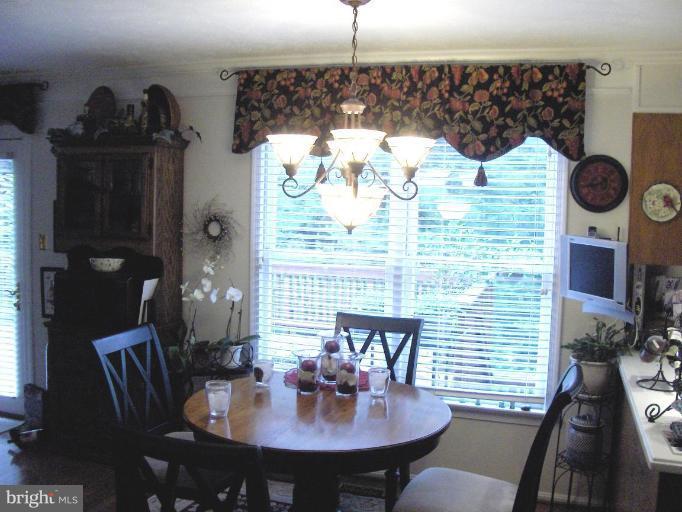 6811 Mallow Court Springfield, VA 22152 - Photo 7 of 30 a view of a dining room with furniture and wooden floor
