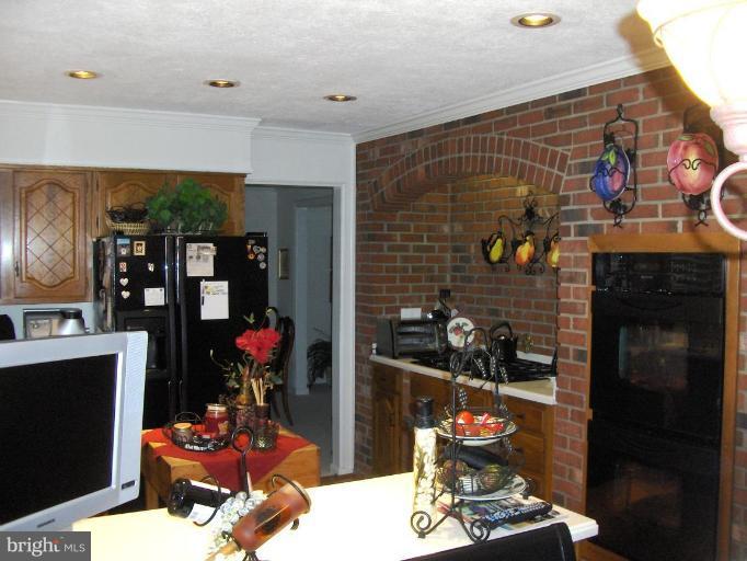 6811 Mallow Court Springfield, VA 22152 - Photo 9 of 30 a room with fireplace and cabinets