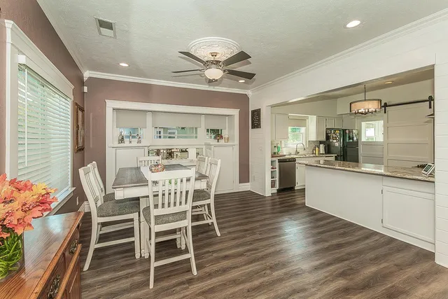 a view of a dining room with furniture and wooden floor