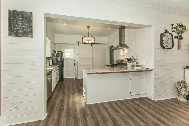 a kitchen with a refrigerator and a sink
