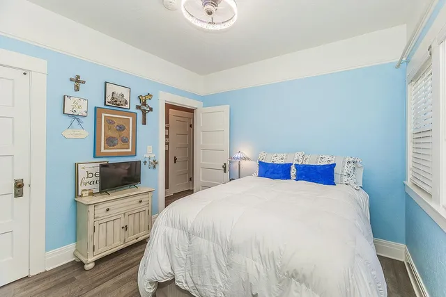 a bedroom with a bed and flat screen tv