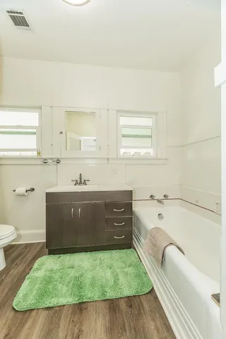 a bathroom with a tub sink and toilet