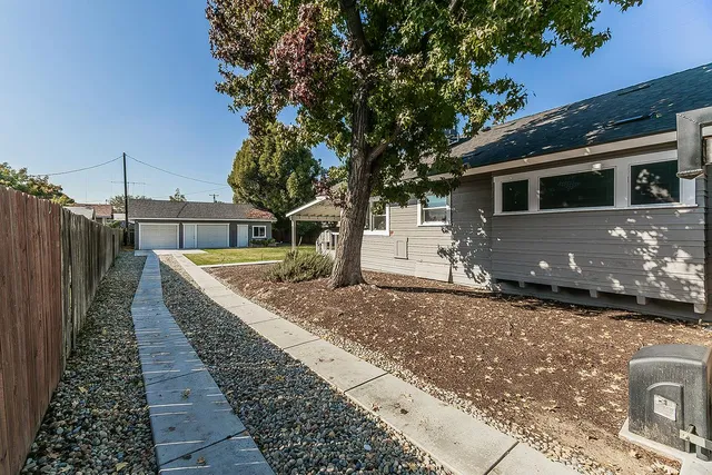 a front view of house with wooden fence