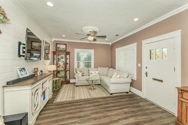 a spacious bedroom with a bed and a chandelier
