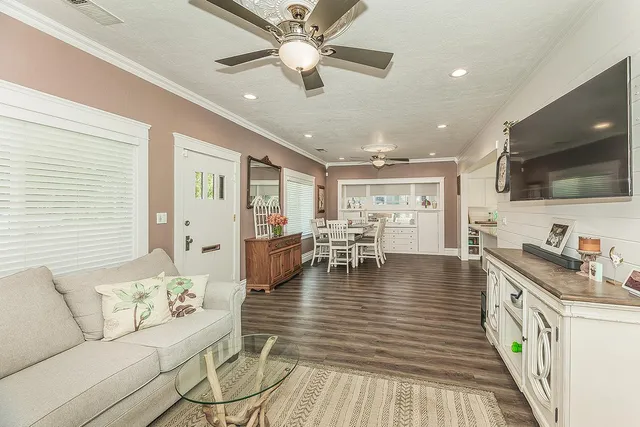 a living room with furniture and a flat screen tv