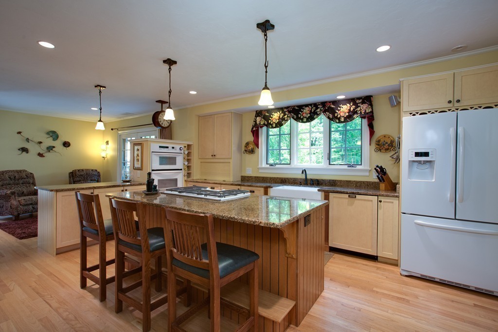 79 East Princeton Road Princeton, MA 01541 - Photo 3 of 30 a kitchen with stainless steel appliances granite countertop a stove a refrigerator a sink dishwasher a dining table and chairs with wooden floor