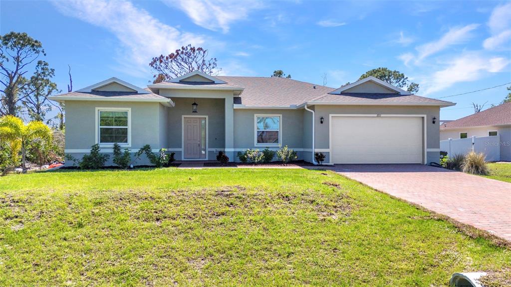 a front view of a house with garden
