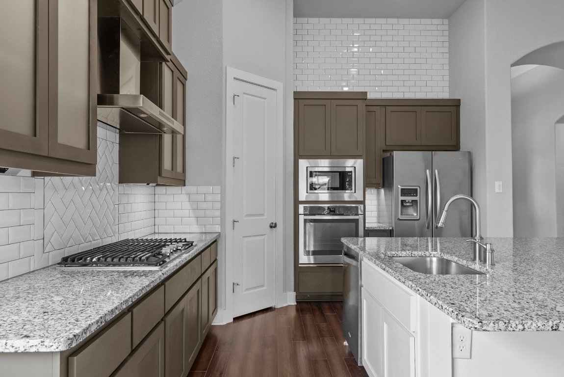 20525 Martin Lane Pflugerville, TX 78660 - Photo 11 of 40 Granite counters, sleek stainless appliances, and designer cabinetry—this kitchen serves looks and function.
