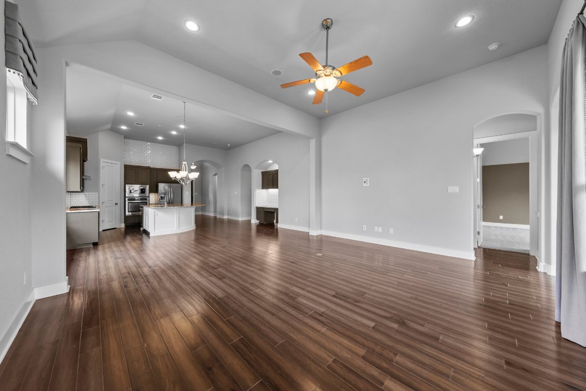 20525 Martin Lane Pflugerville, TX 78660 - Photo 14 of 40 The open-concept layout flows effortlessly, blending beauty and livability with polished wood floors underfoot.