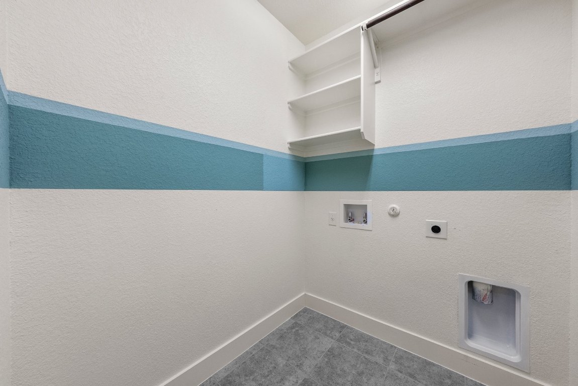 20525 Martin Lane Pflugerville, TX 78660 - Photo 22 of 40 Dedicated laundry room with built-in shelving and utility hookups for easy everyday living.