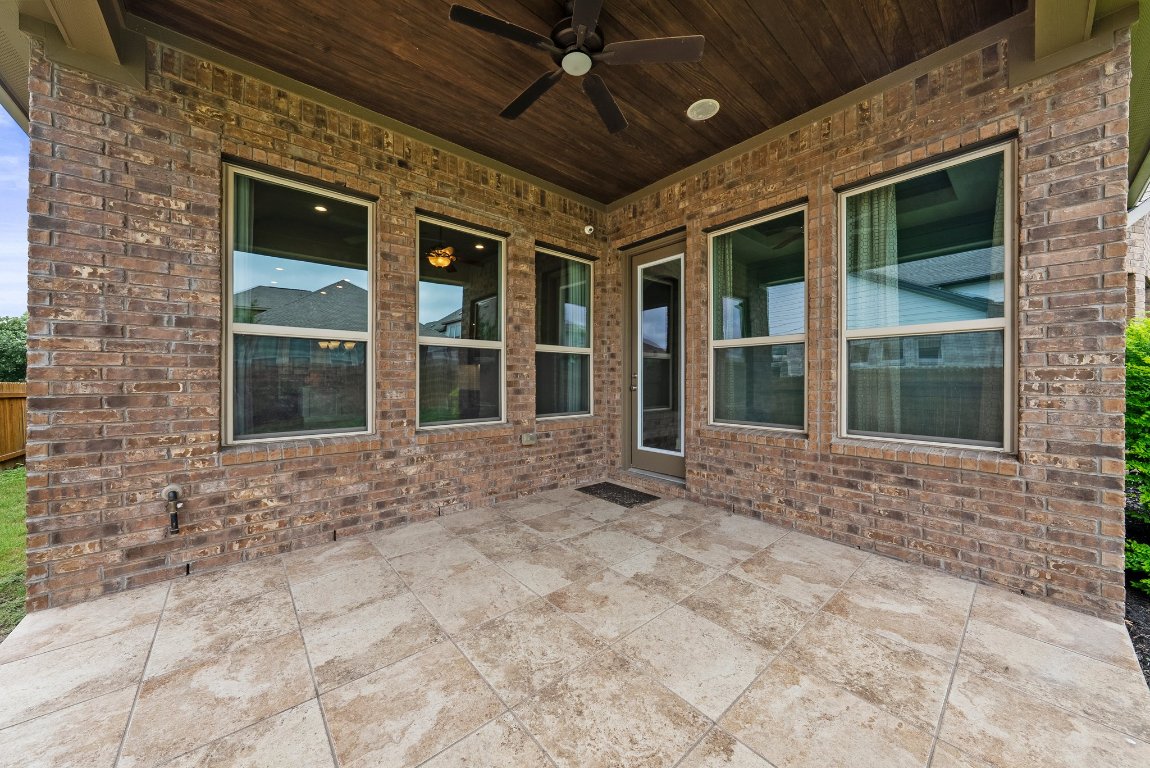 20525 Martin Lane Pflugerville, TX 78660 - Photo 34 of 40 The covered patio’s ready to host your greatest hits: ribs, cold drinks, and that classic backyard playlist.