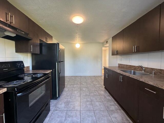 2840 Avenue S A Riviera Beach, Unit 3 Riviera Beach, FL 33404 - Photo 2 of 23 a kitchen with stainless steel appliances granite countertop a stove a sink and a refrigerator