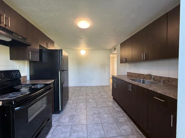 2840 Avenue S A Riviera Beach, Unit 3 Riviera Beach, FL 33404 - Photo 3 of 23 a kitchen with stainless steel appliances granite countertop a refrigerator and a stove