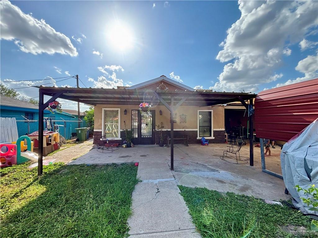 209 Rafael Street Sullivan City, TX 78595 - Photo 1 of 15 a view of a patio with a table and chairs under an umbrella