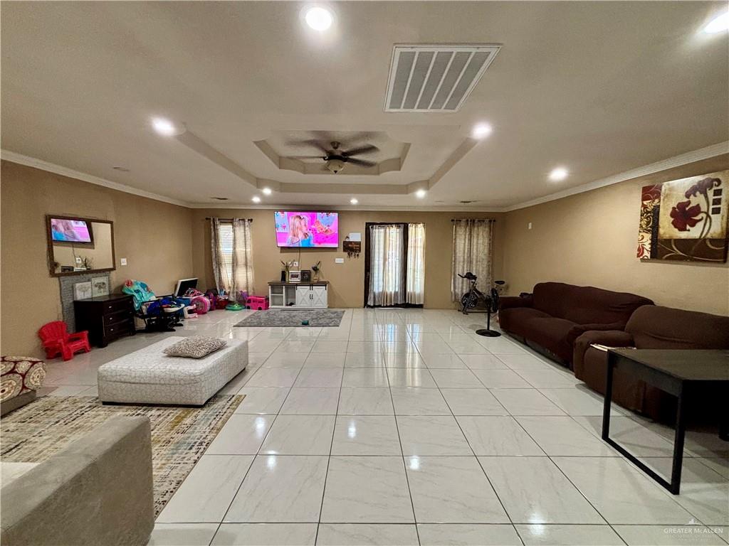 209 Rafael Street Sullivan City, TX 78595 - Photo 2 of 15 a living room with furniture and a flat screen tv