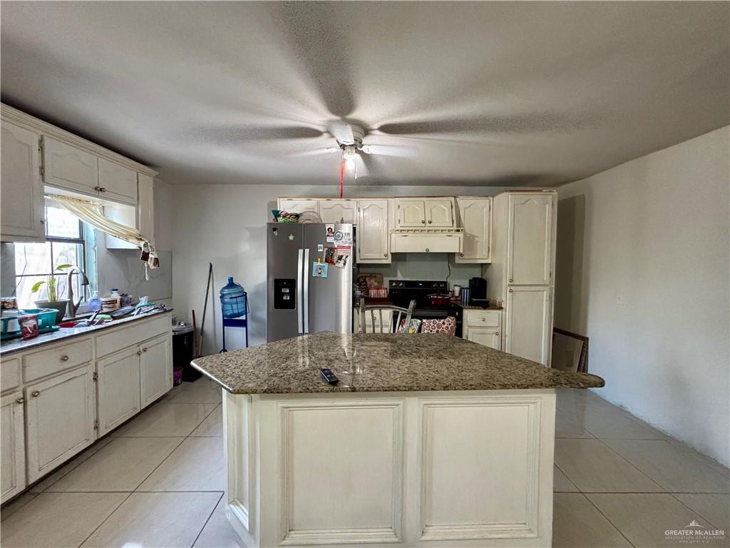 209 Rafael Street Sullivan City, TX 78595 - Photo 4 of 15 a kitchen with stainless steel appliances granite countertop a sink and dishwasher