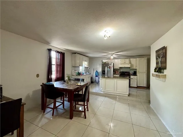 a dining area with furniture and window