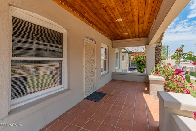 a view of an entryway with a lot of flower in front of balcony