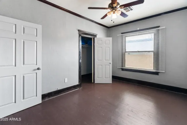 a view of a livingroom with wooden floor and a window