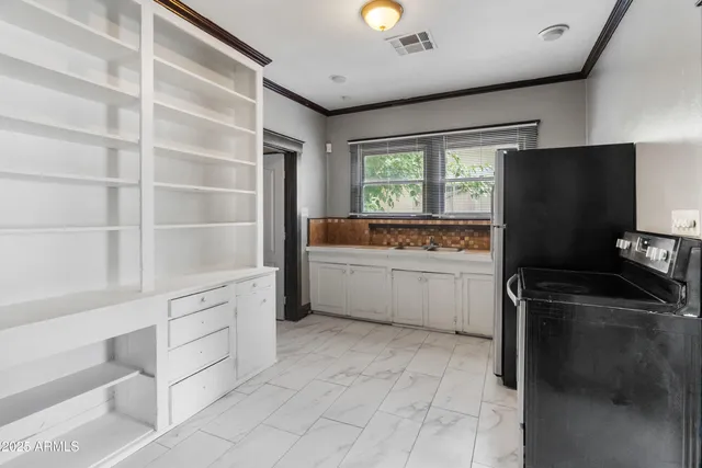 a kitchen with stainless steel appliances granite countertop a refrigerator and a stove top oven