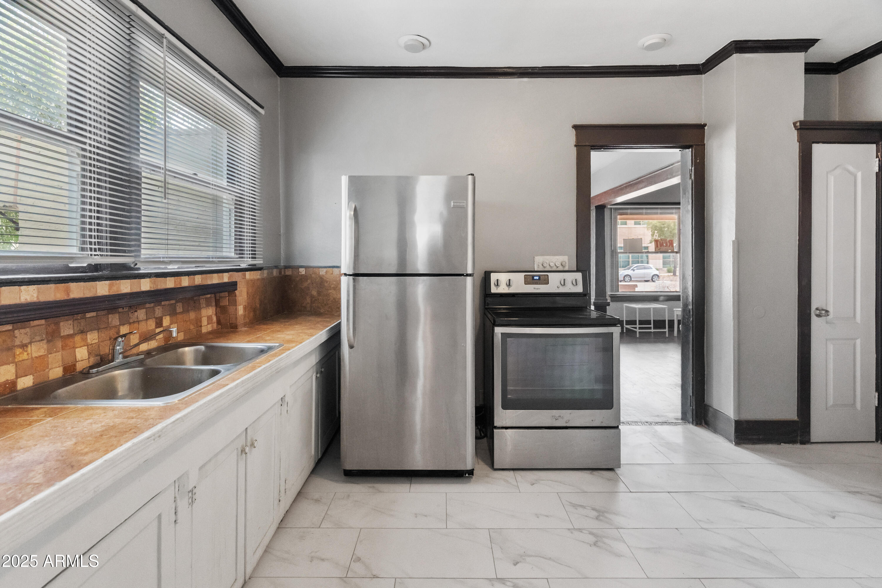 122 North 9th Avenue Phoenix, AZ 85007 - Photo 21 of 43 a kitchen with a refrigerator and a sink