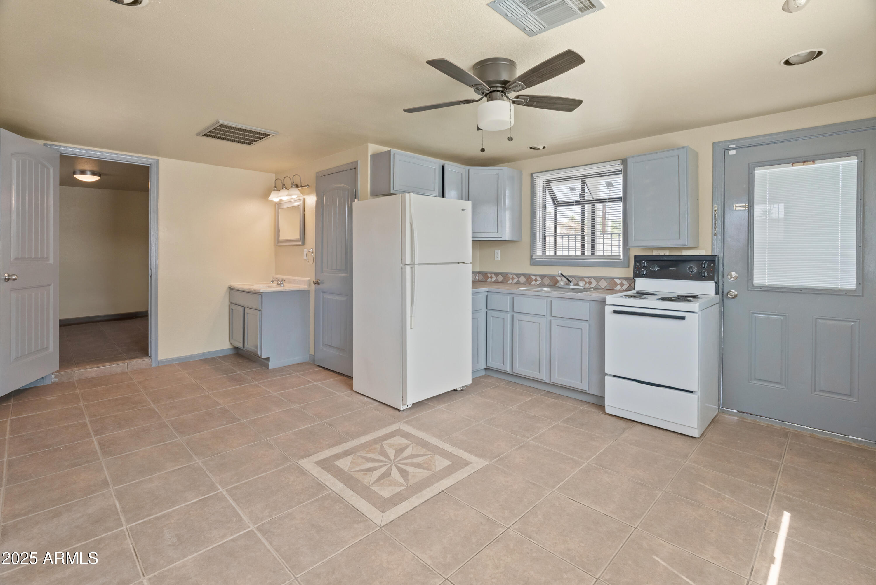 122 North 9th Avenue Phoenix, AZ 85007 - Photo 35 of 43 a kitchen with stainless steel appliances a refrigerator sink and cabinets