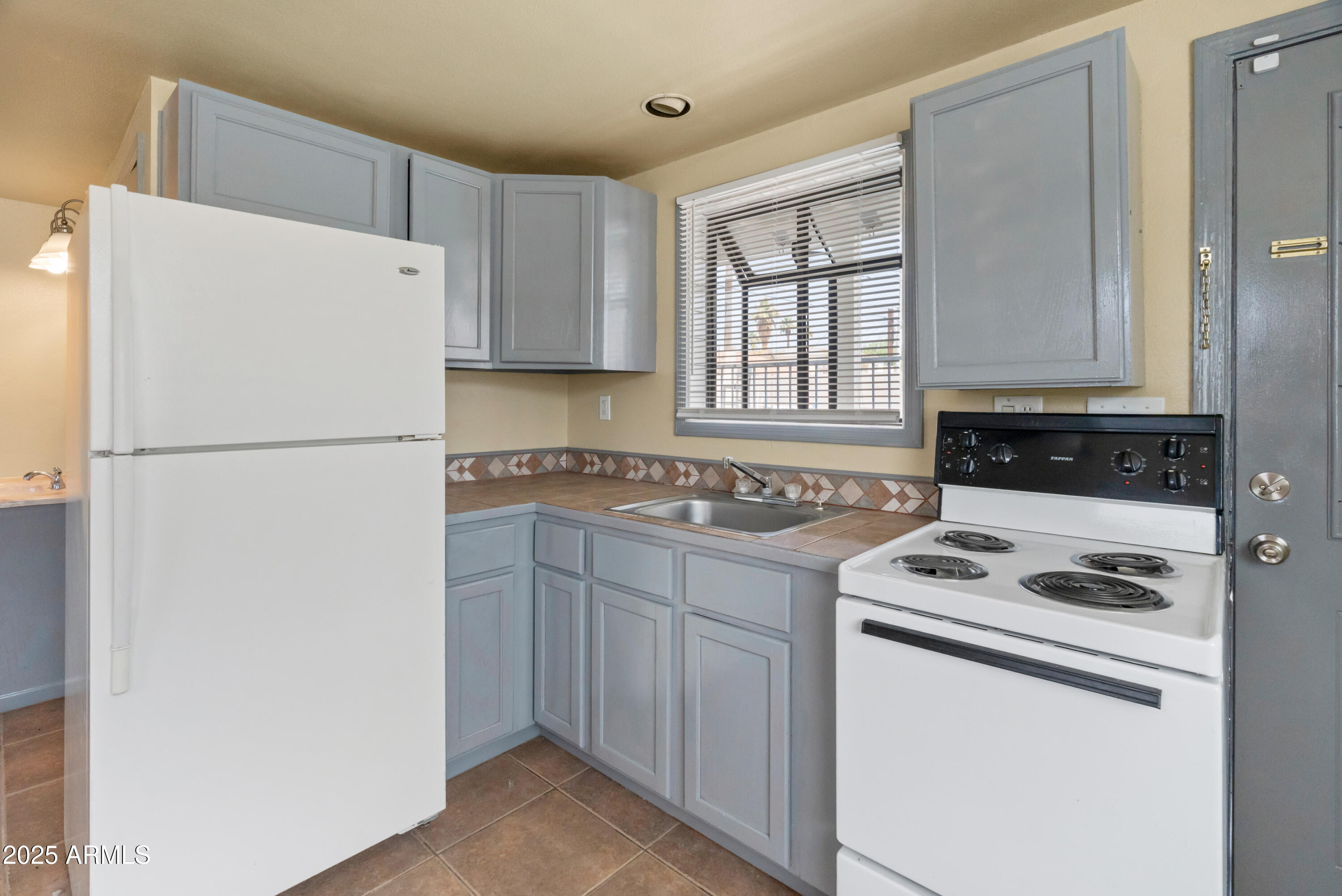 122 North 9th Avenue Phoenix, AZ 85007 - Photo 37 of 43 a white refrigerator freezer sitting inside of a kitchen