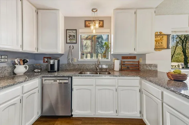 a kitchen with sink cabinets and window