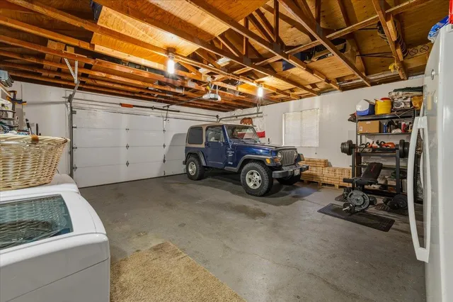 a roof deck with table and chairs and potted plants