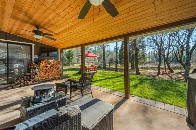 a view of an outdoor sitting area with furniture and umbrella